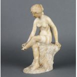 A carved marble figure of a seated classical girl, raised on a rocky outcrop 30cm x 10cm x 16cm Foot