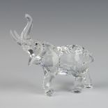 A Swarovski Crystal figure of a standing elephant with his trunk raised 11cm, boxed