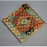 A white, yellow and green ground Chobi Kilim slip rug with all-over geometric design 50cm x 52cm