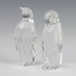 A Swarovski Crystal figure of a penguin with downturned beak 11cm, ditto with an upturned beak 12cm,