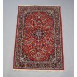 A red and blue ground Sarourgh rug with central medallion 186cm x 124cm Some flecking and wear in