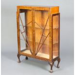A 1930's Art Deco mahogany display cabinet, fitted glazed shelves, enclosed by an astragal