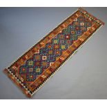 A yellow, turquoise and orange ground Chobi Kilim runner with all-over geometric design 243cm x 79cm