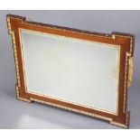 An Empire style rectangular bevelled plate over mantel mirror contained in a gilt and walnut frame