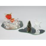 A Swarovski figure of Father Christmas 6cm, ditto sleigh 4cm with mirrored plints, presents and