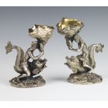 A pair of Victorian cast silver plated table salts, in the form of a sea god and goddess riding