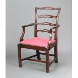 A 19th Century mahogany London ladder back carver chair with upholstered drop in seat, raised on