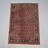 A brown and blue ground Tabriz rug with all over geometric design 181cm x 119cm Flecking in places