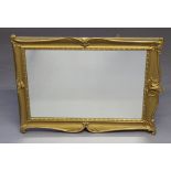 A 20th Century Victorian style rectangular plate wall mirror contained in a decorative gilt frame