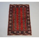 A red and blue ground Bokhara rug with 42 octagons to the centre within a multi row border (in wear)