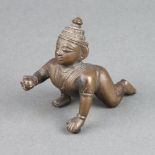 A Burmese bronze figure of a kneeling man 6cm h x 8cm