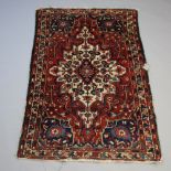 A brown, white and blue ground Persian rug with central medallion 196cm x 135cm The rug is worn in