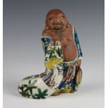 A Chinese glazed figure of a standing Hotei 20cm The figure has a crack to the base