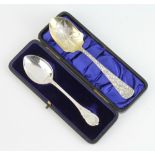 An American cast sterling jam spoon decorated with flowers together with a lily pattern ditto 56