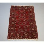 A red and blue ground Bokhara rug with 12 octagons to the centre within a multi row border 175cm x