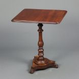 A William IV rectangular mahogany snap top wine table, raised on a turned bulbous column and triform