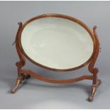 A 19th/20th Century Chippendale style oval plate dressing table mirror contained in a mahogany swing