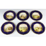 A set of Spode dessert plates with blue and gilt rims enclosing views of Rochester Castle, Dover