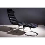 A BLACK LEATHER AND CHROME EASY CHAIR AND STOOL