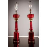 A PAIR OF RUBY GLASS AND BRASS MOUNTED FACETTED TABLE LAMPS