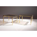 A PAIR OF GILT LOW TABLES, 1970s, with smoked glas