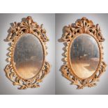 A PAIR OF GILTWOOD OVAL WALL MIRRORS IN ROCOCO STYLE