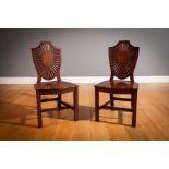 A PAIR OF GEORGIAN MAHOGANY HALL CHAIRS