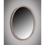 AN IRISH CLEAR GLASS STUDDED OVAL MIRROR, C.1800,  60cms high x  42cms wide