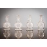 A SET OF FOUR CUT GLASS DECANTERS