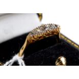 A LADY'S PERIOD 18CT YELLOW GOLD FIVE STONE DIAMOND RING with pierced scrolled mount, stamped