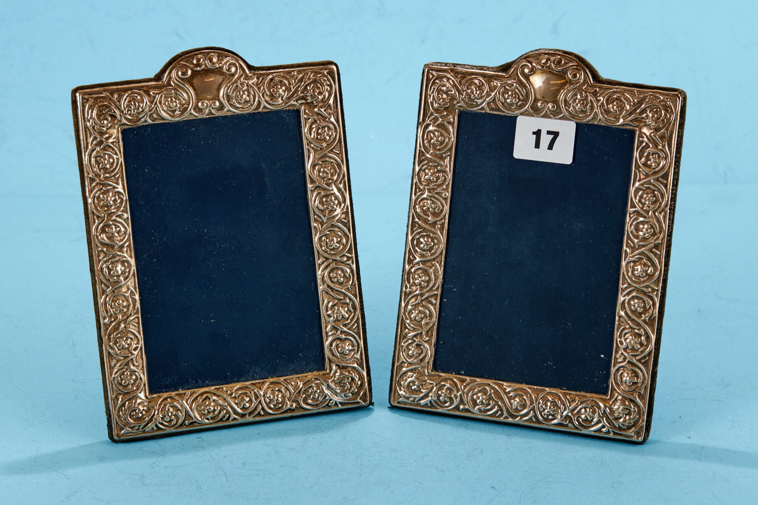 A PAIR OF ELIZABETH II FOLIATE EMBOSSED PHOTO FRAMES of arched rectangular form, maker: RC, 1993,