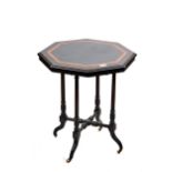 A LATE VICTORIAN OCTAGONAL EBONISED AND AMBOYNA BANDED OCCASIONAL TABLE raised on round stop