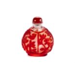 A 20TH CENTURY CHINESE PEKIN CARVED RED/CLEAR GLASS SNUFF BOTTLE, tree and bird design, red domed