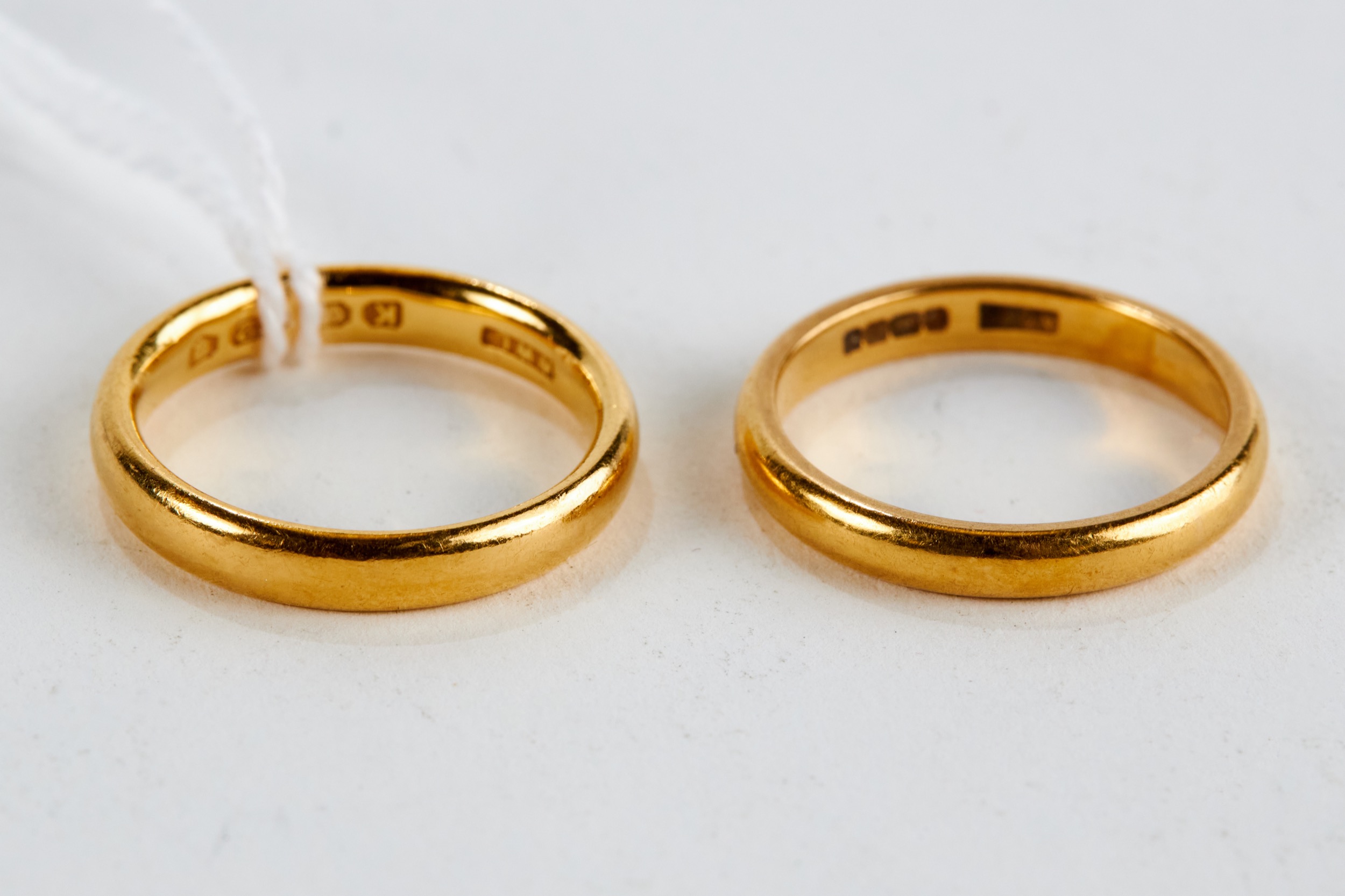 A 22CT YELLOW GOLD WEDDING BAND and a similar 22ct gold DITTO, approximately 10 grams. (2)