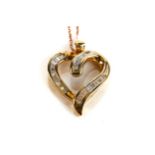 A 10K YELLOW GOLD HEART SHAPED PENDANT pave set with diamonds on a 10k fine link chain,
