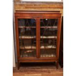 AN EDWARDIAN INLAID MAHOGANY DOUBLE DOOR DISPLAY CABINET, the marquetry ribbon and swag inlaid top