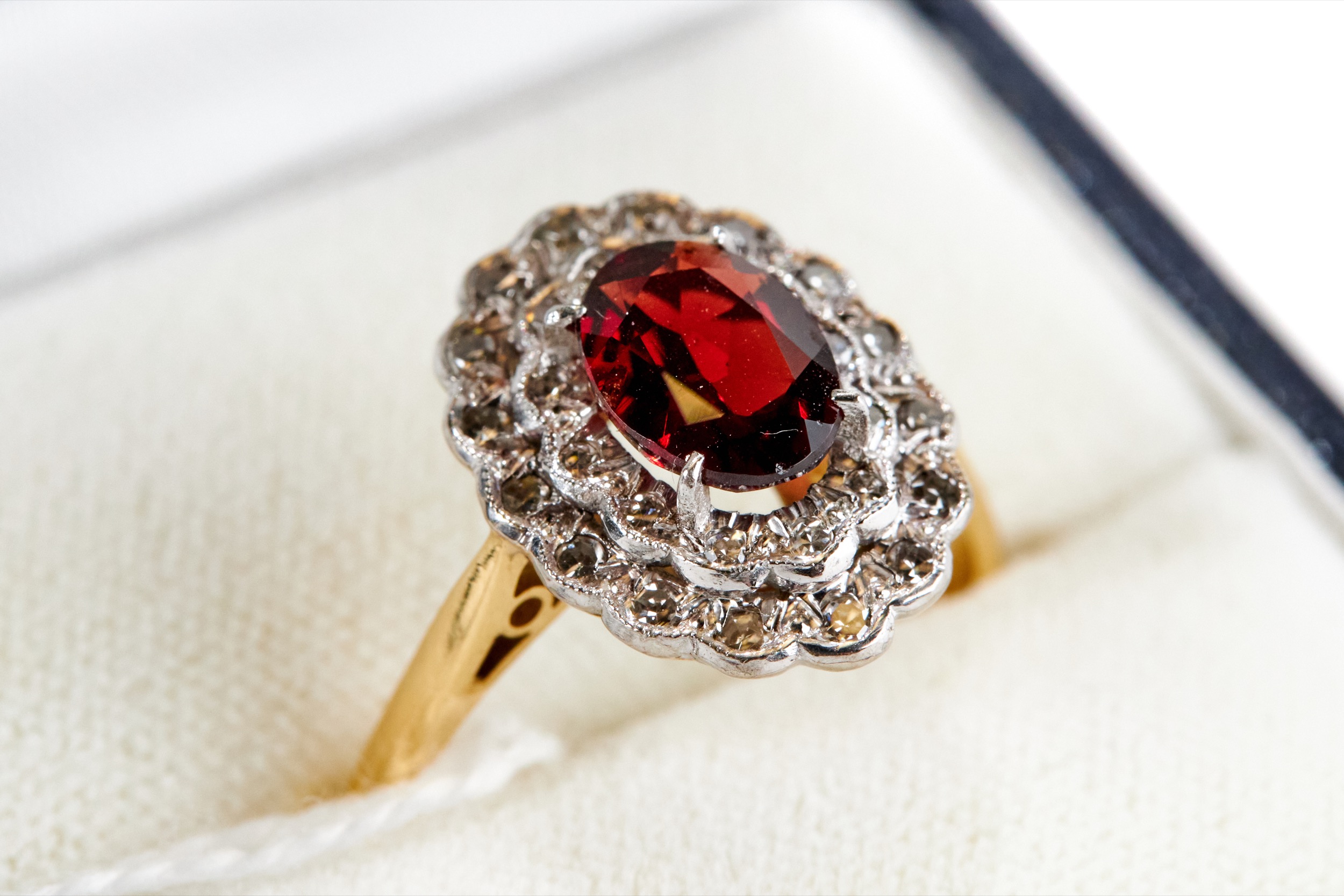 A LADY'S 18CT YELLOW GOLD GARNET AND DIAMOND RING, stamped 18ct, size P, approximately 4.4 grams.