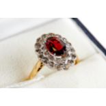 A LADY'S 18CT YELLOW GOLD GARNET AND DIAMOND RING, stamped 18ct, size P, approximately 4.4 grams.