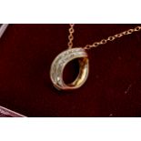 A 10K YELLOW GOLD PEAR SHAPED PENDANT, set with eighteen diamonds on a 9ct gold neckchain,