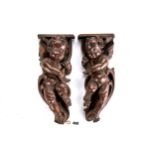 A PAIR OF LATE 19TH CENTURY CARVED OAK WINGED CHERUB CARVINGS, each 13 ins high.