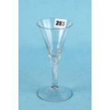 AN 18TH CENTURY TRUMPET BOWL WINE GLASS raised on a clear spiral twist stem and large circular