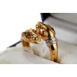 A LADY'S 9CT YELLOW DOUBLE PANTHER HEAD RING, diamond set collars and ruby eyes, size P,