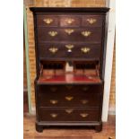 AN 18TH CENTURY CONTINENTAL OAK SECRETAIRE CHEST ON CHEST, the moulded cornice above three short and