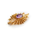 A 9CT YELLOW GOLD SUNBURST STYLE BROOCH set with an amethyst, stamped H.B.J 375, approximately 8.4