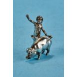 A LATE VICTORIAN CAST SILVER CUPID AND PIG ORNAMENT, maker BM (Berthold Muller), Chester 1899,