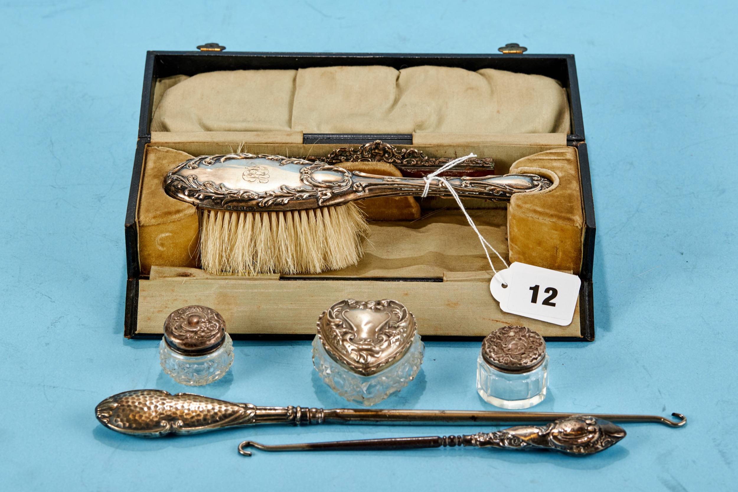 AN EDWARDIAN SILVER HAIR BRUSH AND COMB SET with embossed decoration maker: L&S, Birmingham 1905