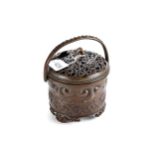 A 19TH CENTURY CHINESE BRONZE CENSER of circular form with a swing handle, dragon tail handle, six