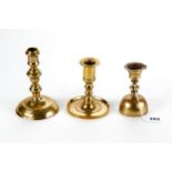 AN 18TH CENTURY BRASS CANDLESTICK with inverted acorn stem on a circular base, 6 ins high, a small