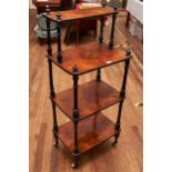 A VICTORIAN WALNUT AND EBONISED FOUR TIER WHATNOT raised on turned legs with brass and ceramic