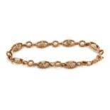 A 9CT YELLOW GOLD OVAL ROPE TWIST AND CROWN MOTIF BRACELET, stamped 9.375, approximately 11.5 grams.